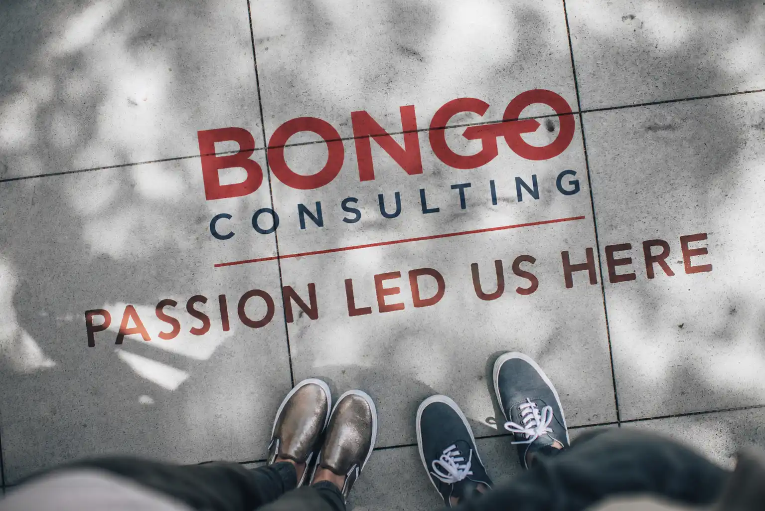 Shoes on sidewalk with Bongo logo and text sating passion led us here